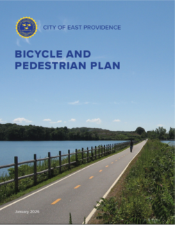 Report Cover titled East Providence Bicycle and Pedestrian Plan with photo of a bike path by the water with a cyclist riding on the path